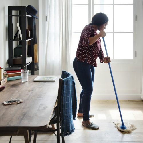 Black woman cleaning room