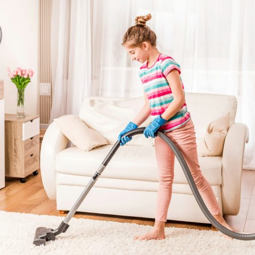 Girl is cleaning carpet